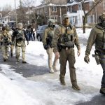 ICE-agents-stand-at-the-scene-where-ICE-agents-fatally-shoot-a-woman-earlier-in-the-day-in-Minneapolis-Minnesota-011226-b5ad95a934cc426692a2142c61def69f