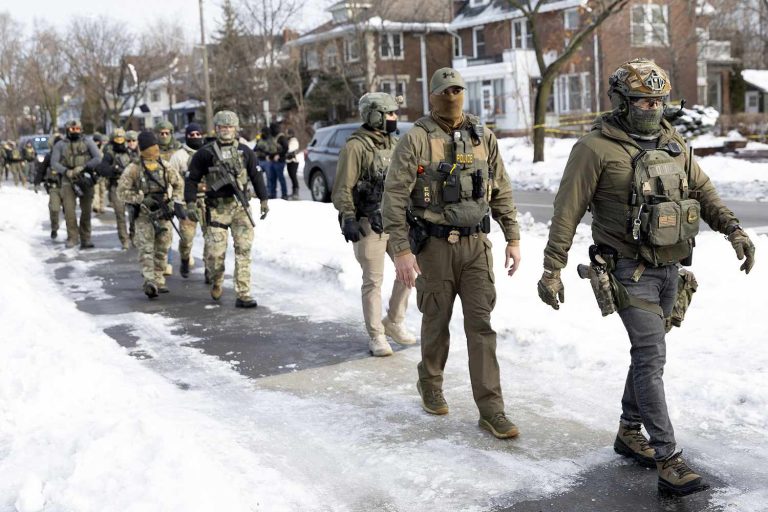 ICE-agents-stand-at-the-scene-where-ICE-agents-fatally-shoot-a-woman-earlier-in-the-day-in-Minneapolis-Minnesota-011226-b5ad95a934cc426692a2142c61def69f
