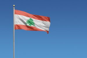 Flag of Lebanon in front of a clear blue sky