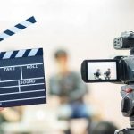 Man hands holding movie clapper.