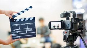 Man hands holding movie clapper.
