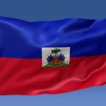 Haiti flag waving on the flagpole on a sky background