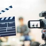 Man hands holding movie clapper.