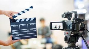 Man hands holding movie clapper.